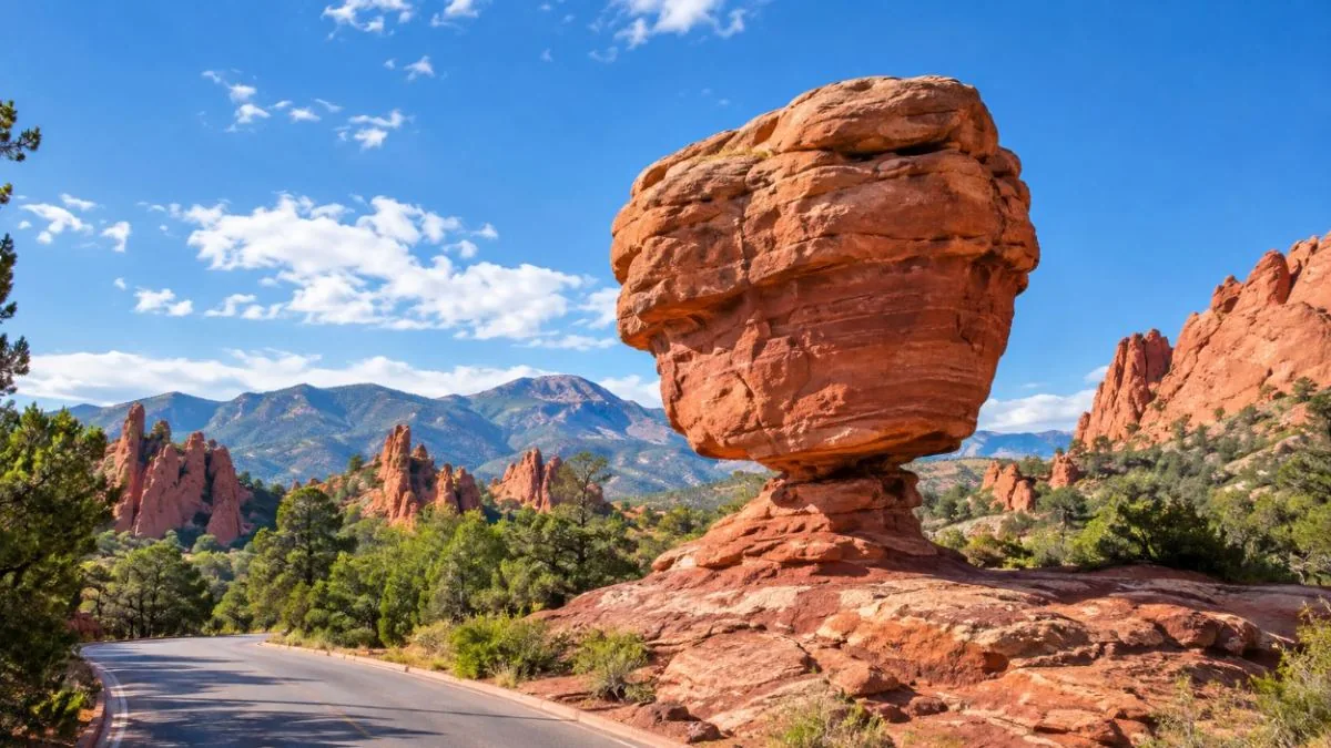 Balanced Rock, a huge red boulder resting on a narrow base beside the park road