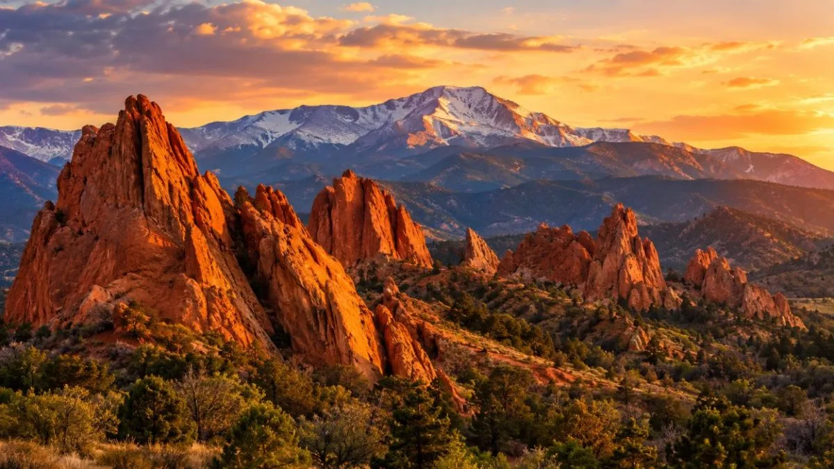 Late afternoon light on the red rocks with Pikes Peak behind them